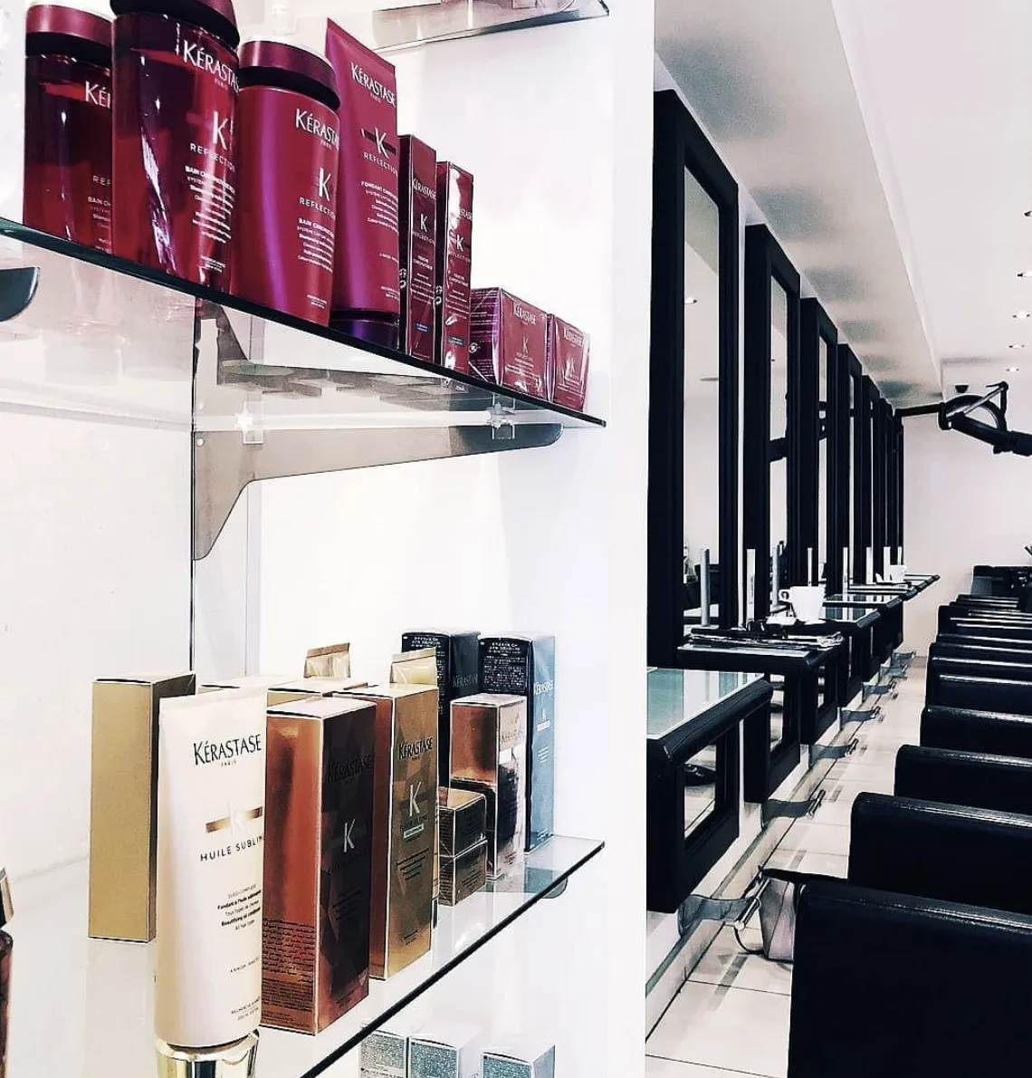 Kérastase retail shelving inside Raw Edge salon, mirror row receding in the background
